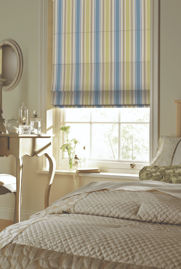 Blue and Yellow Striped Roman Blinds in a Bedroom