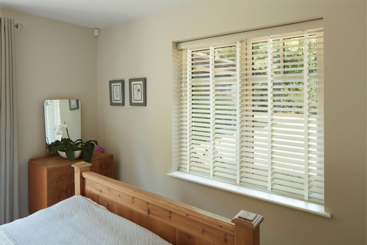 White Venetian Blinds in a Bedroom Window
