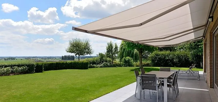 Large white patio awning over an outdoor dining table