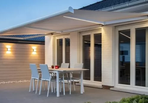 A white awning at night over a terrace