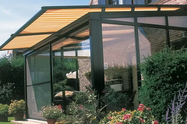 An awning over a glass room providing shade