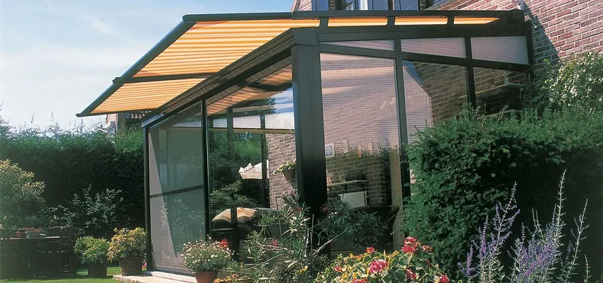 An awning over a glass room providing shade