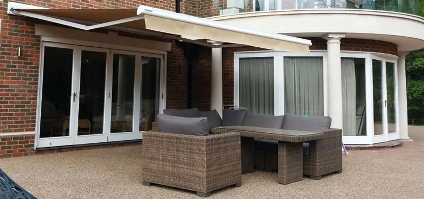 Beige awning over patio furniture